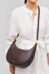 Profile view of model wearing the Oroton Florence Medium Hobo in Mahogany and  for Women