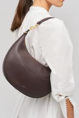 Profile view of model wearing the Oroton Florence Medium Hobo in Mahogany and  for Women