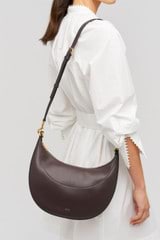 Profile view of model wearing the Oroton Florence Medium Hobo in Mahogany and  for Women