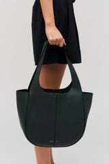 Profile view of model wearing the Oroton Emilia Tote in Vine and  for Women