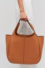 Profile view of model wearing the Oroton Emilia Large Tote in Brandy and  for Women