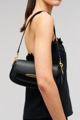 Profile view of model wearing the Oroton Nelle Baguette in Black and Smooth leather material for Women