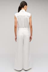 Profile view of model wearing the Oroton Wide Curved Leg Pant in White and 100% cotton material for Women