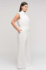 Profile view of model wearing the Oroton Wide Curved Leg Pant in White and 100% cotton material for Women