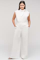 Profile view of model wearing the Oroton Wide Curved Leg Pant in White and 100% cotton material for Women