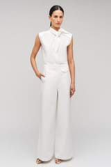 Profile view of model wearing the Oroton Wide Curved Leg Pant in White and 100% cotton material for Women