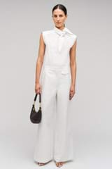 Profile view of model wearing the Oroton Wide Curved Leg Pant in White and 100% cotton material for Women