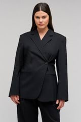 Profile view of model wearing the Oroton Wrap Blazer in Black and 98% wool,  2% elastane material for Women