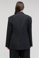 Profile view of model wearing the Oroton Wrap Blazer in Black and 98% wool,  2% elastane material for Women