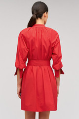 Profile view of model wearing the Oroton Lace Detail Smock Dress in Poppy and 100% cotton material for Women