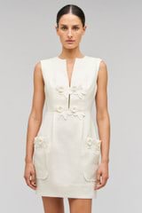 Profile view of model wearing the Oroton Rosebud Lace Mini Dress in Soft Cream and 100% linen material for Women