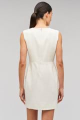 Profile view of model wearing the Oroton Rosebud Lace Mini Dress in Soft Cream and 100% linen material for Women