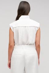 Profile view of model wearing the Oroton Sleeveless Tie Neck Shirt in White and 100% cotton material for Women