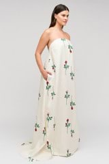 Profile view of model wearing the  Rosebud Gown in Antique White and 100% linen material for Women