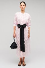 Profile view of model wearing the Oroton Scallop Lace Shirt Dress in Pink Rose and 85% Tencel 15% Polyester Material for Women