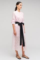 Profile view of model wearing the Oroton Scallop Lace Shirt Dress in Pink Rose and 85% Tencel 15% Polyester Material for Women