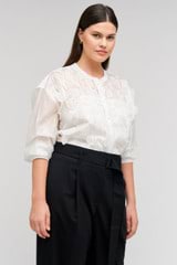 Profile view of model wearing the Oroton Scallop Lace Overshirt in White and 85% Tencel 15% Polyester for Women