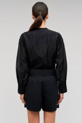 Profile view of model wearing the Oroton Scallop Lace Overshirt in Black and 85% Tencel 15% Polyester for Women