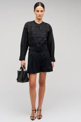 Profile view of model wearing the Oroton Scallop Lace Overshirt in Black and 85% Tencel 15% Polyester for Women