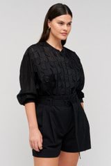 Profile view of model wearing the Oroton Scallop Lace Overshirt in Black and 85% Tencel 15% Polyester for Women