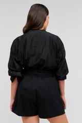 Profile view of model wearing the Oroton Scallop Lace Overshirt in Black and 85% Tencel 15% Polyester for Women