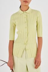 Profile view of model wearing the Oroton 1/2 Sleeve Rib Cardi in Pistachio and 77% Viscose 23% Polyester for Women