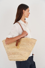 Profile view of model wearing the Oroton Madison Large Tote in Natural/Brandy and Straw/Smooth Leather Trims for Women