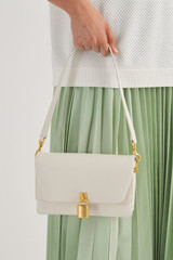 Profile view of model wearing the Oroton Tate Small Day Bag in Paper White and Pebble Leather for Women