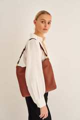 Profile view of model wearing the Oroton Tessa Large Hobo in Toffee and Soft Pebble Leather for Women