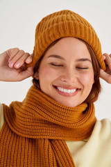 Profile view of model wearing the Oroton Woods Knit Beanie in Tan and 100% Merino Wool for Women