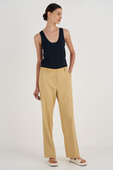 Profile view of model wearing the Oroton Relaxed Leg Pant in Raffia and 81% Viscose, 17% Cotton, 2% Elastane for Women