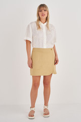 Profile view of model wearing the Oroton Pocket Detail Skirt in Raffia and 81% Viscose, 17% Cotton, 2% Elastane for Women