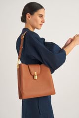 Profile view of model wearing the Oroton Tate Hobo in Brandy and Pebble Leather for Women