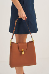 Profile view of model wearing the Oroton Tate Hobo in Brandy and Pebble Leather for Women
