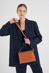 Profile view of model wearing the Oroton Sadie Crossbody in Toffee and Pebble Leather for Women
