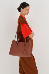 Profile view of model wearing the Oroton Margot Large Day Bag in Whiskey and Pebble Leather for Women