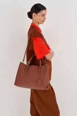 Profile view of model wearing the Oroton Margot Large Day Bag in Whiskey and Pebble leather for Women