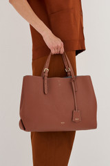 Profile view of model wearing the Oroton Margot Large Day Bag in Whiskey and Pebble Leather for Women