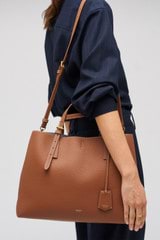 Profile view of model wearing the Oroton Margot Large Day Bag in Whiskey and Pebble leather for Women