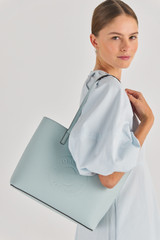 Profile view of model wearing the Oroton Polly Medium Tote in Duck Egg and Pebble Leather for Women