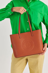 Profile view of model wearing the Oroton Polly Medium Tote in Cognac and Pebble Leather for Women
