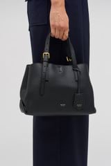 Profile view of model wearing the Oroton Margot Mini Day Bag in Black and Pebble Leather for Women
