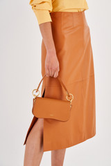 Profile view of model wearing the Oroton Liv Small Day Bag in Maple and Small Pebble Leather for Women