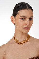Profile view of model wearing the Oroton Riley Necklace in Worn Gold and Brass Base With 18CT Gold Plating for Women