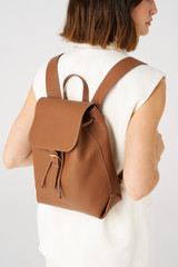 Profile view of model wearing the Oroton Margot Medium Backpack in Whiskey and Pebble Leather for Women