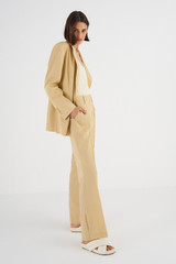 Profile view of model wearing the Oroton Split Hem Pant in Cane Sugar and 66% Viscose 34% Cotton for Women