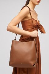 Profile view of model wearing the Oroton Margot Hobo in Whiskey and Pebble leather for Women
