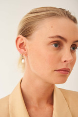 Profile view of model wearing the Oroton Violet Pearl Earrings in Gold/White and Brass Base With 18CT Gold Plating for Women