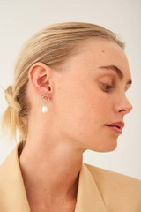 Profile view of model wearing the Oroton Violet Pearl Earrings in Silver/White and Brass Base With Rhodium Plating for Women