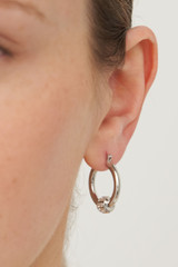 Profile view of model wearing the Oroton Kori Mini Hoops in Silver/Clear and  for Women